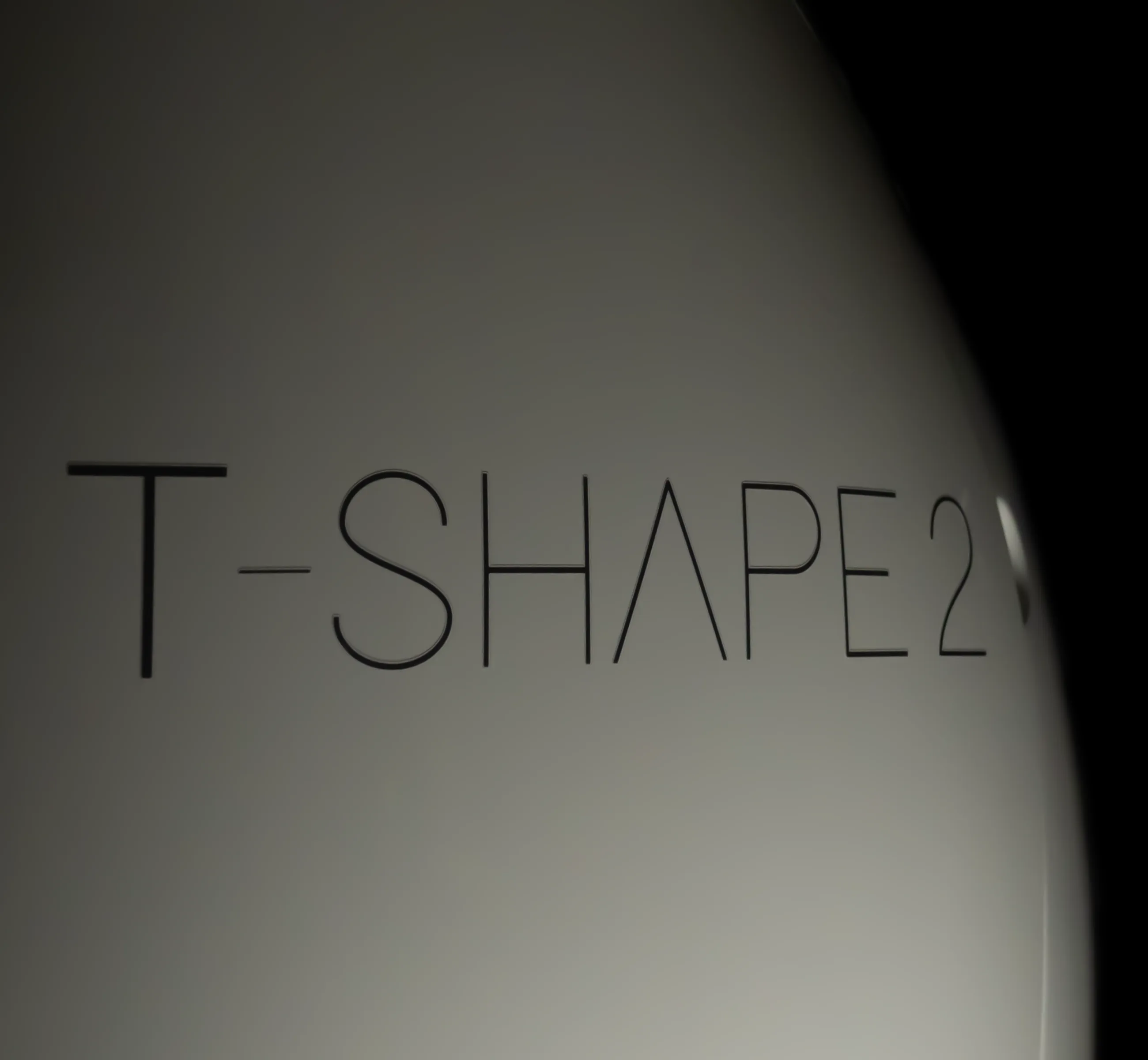 The T-Shape 2 name, moulded into the curved white housing of the platform.