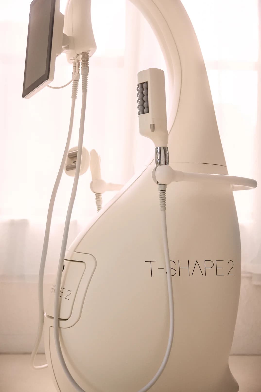 A close view of the T-Shape 2 platform and its handpieces in window light.